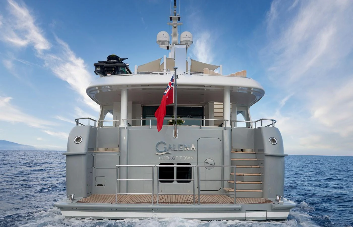 The yacht's aft deck is beautifully showcased with a clear view of the open sea and a serene sky. aboard GALENA Yacht for Sale