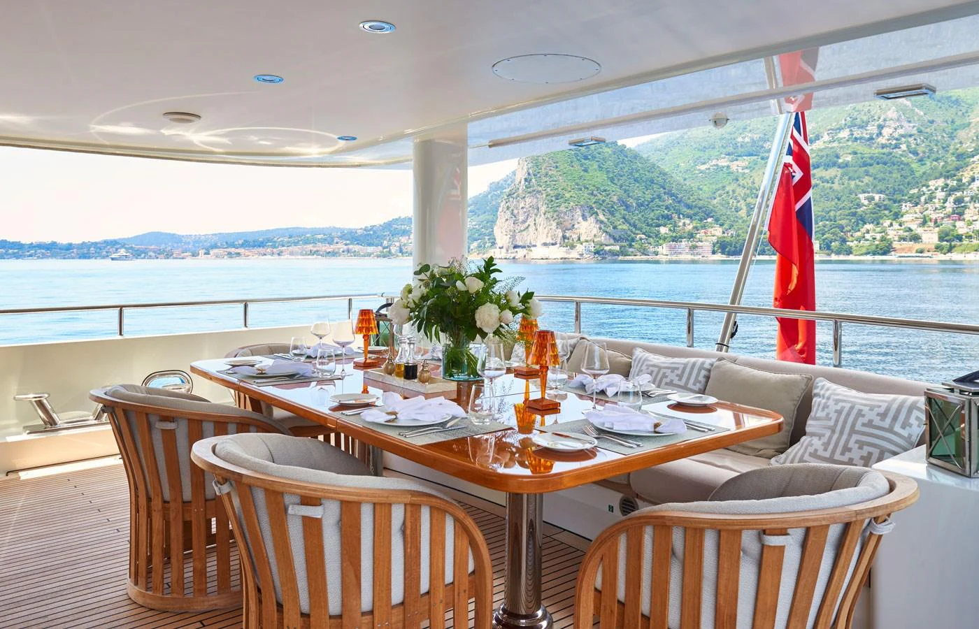 The aft deck features an elegant dining area with a stunning view of the surrounding waters and landscape. aboard GALENA Yacht for Sale