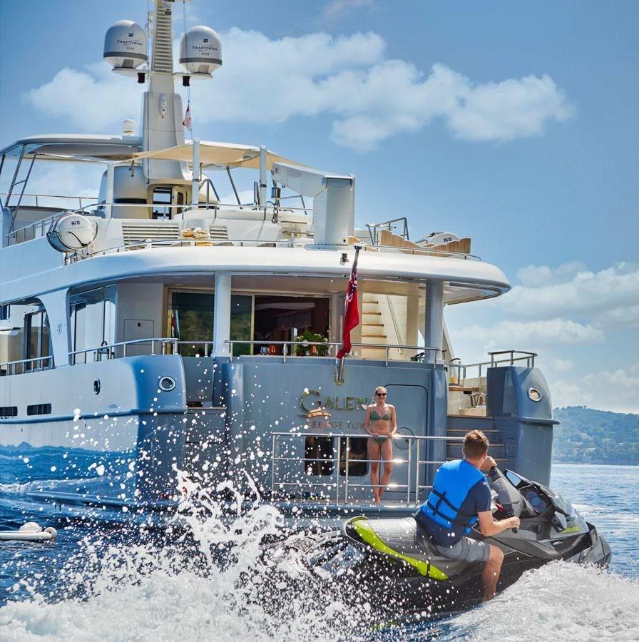 A luxurious yacht with an inviting aft deck, complemented by a jet ski in action on the water. aboard GALENA Yacht for Sale