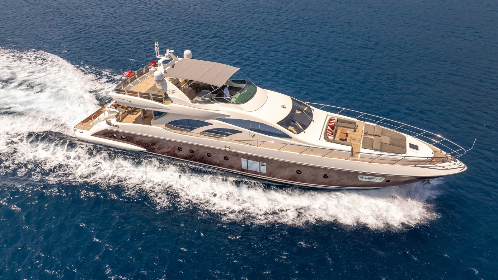 A sleek and luxurious yacht cruises through the open sea, showcasing its elegant design and spacious deck areas. aboard EROSSEA Yacht for Sale