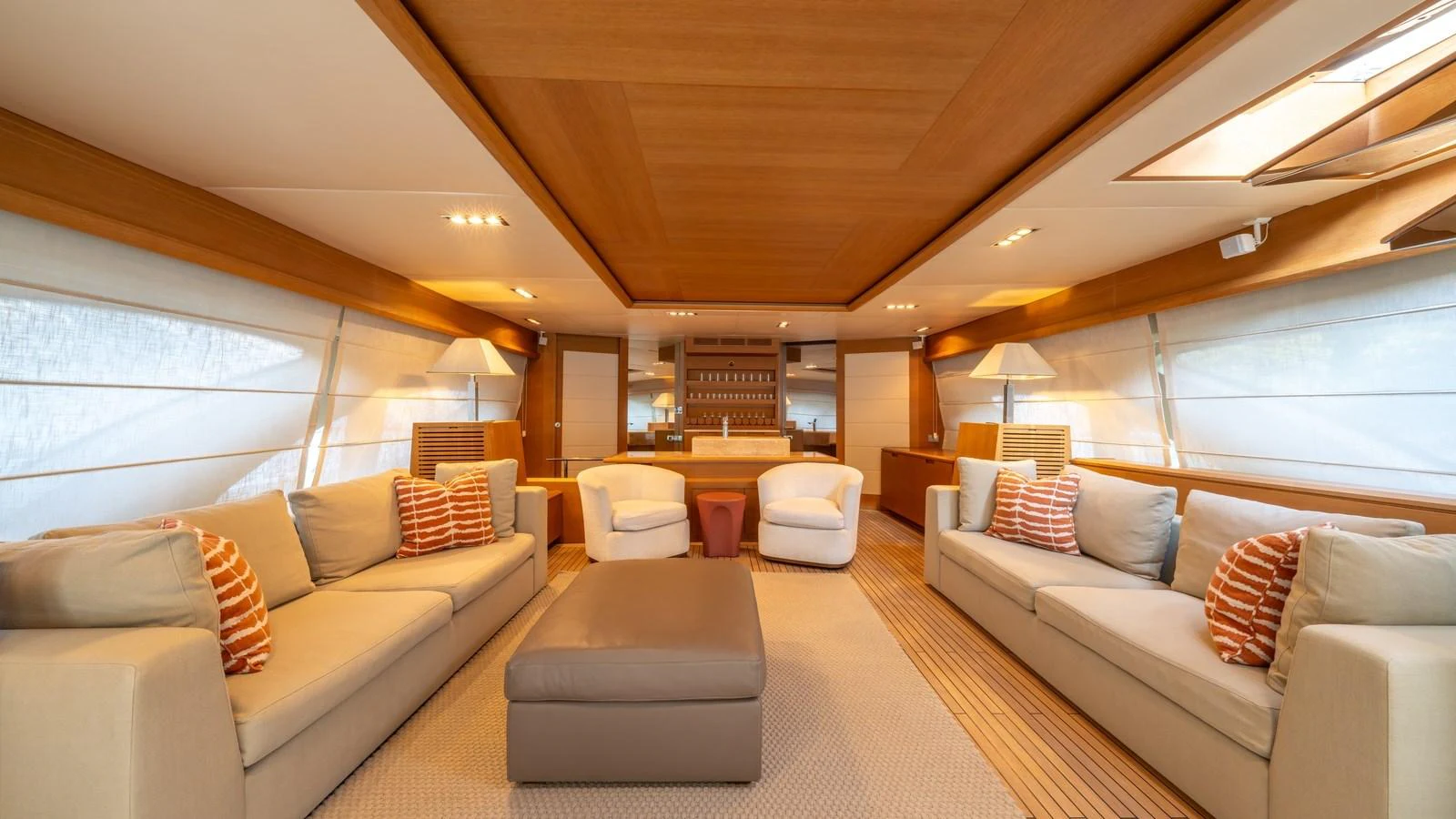 The salon features plush seating, warm wood accents, and ample natural light for a cozy and inviting atmosphere. aboard EROSSEA Yacht for Sale