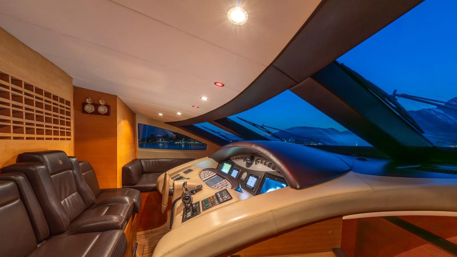 The helm of this yacht features luxurious leather seating and state-of-the-art navigation equipment, set against a backdrop of panoramic windows. aboard EROSSEA Yacht for Sale
