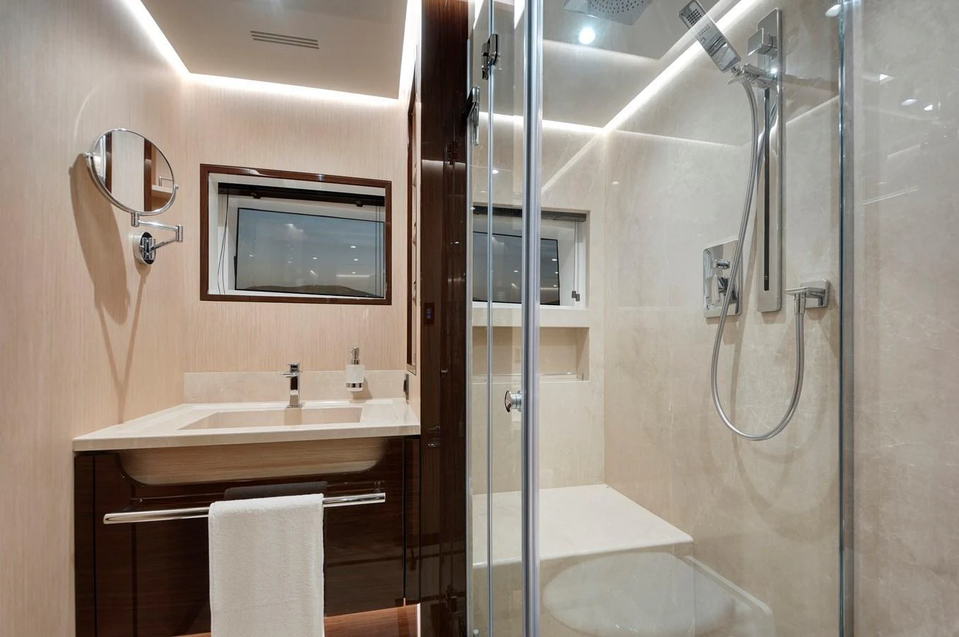 A modern and luxurious yacht bathroom with sleek fixtures and a spacious shower. aboard LAZZARA UHV 90 Yacht for Sale