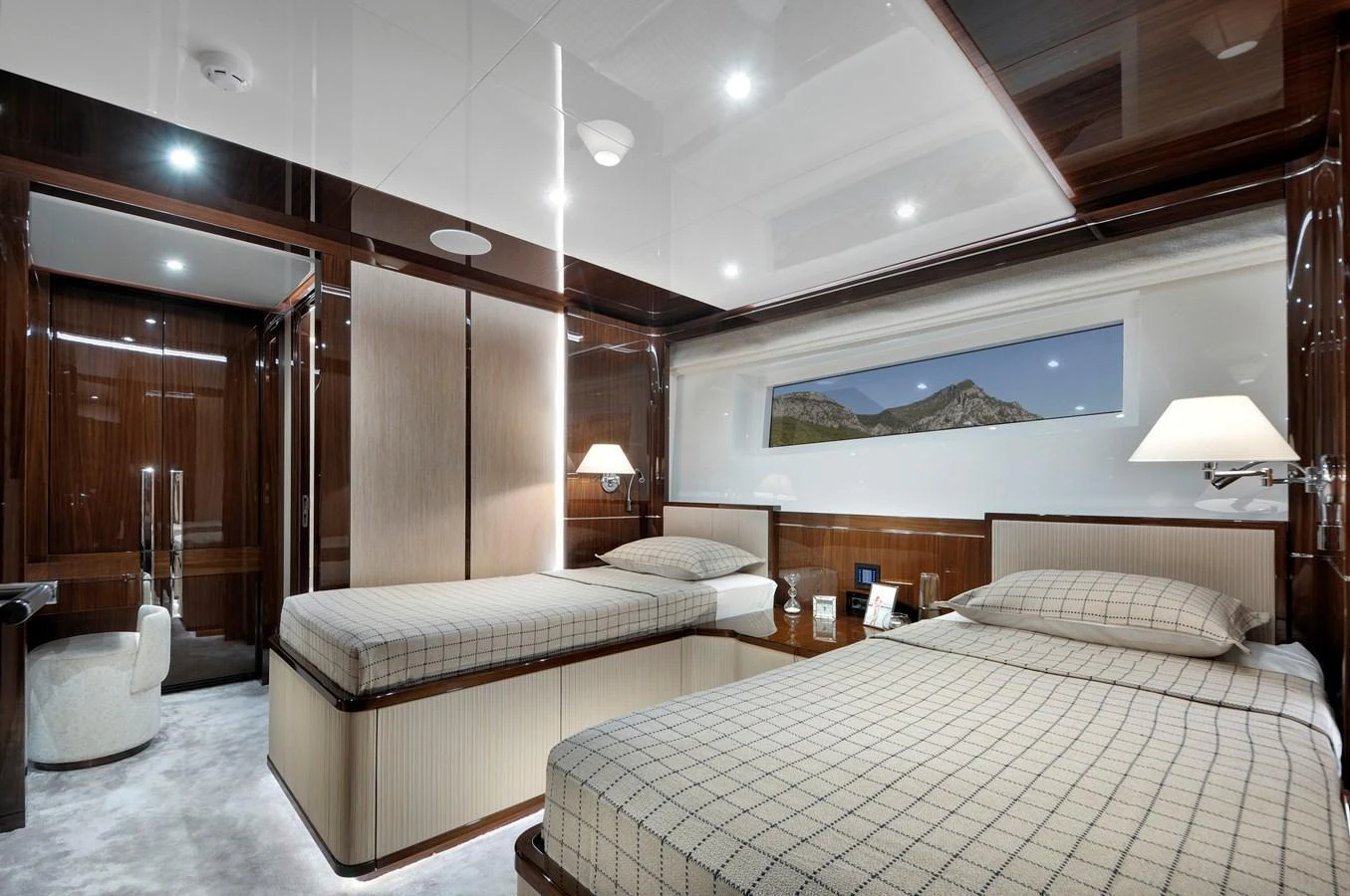 The guest stateroom features twin beds with elegant wood paneling and modern lighting. aboard LAZZARA UHV 90 Yacht for Sale