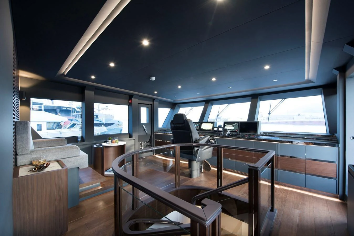 The helm station features modern navigation equipment and luxurious seating with panoramic views. aboard LAZZARA UHV 90 Yacht for Sale
