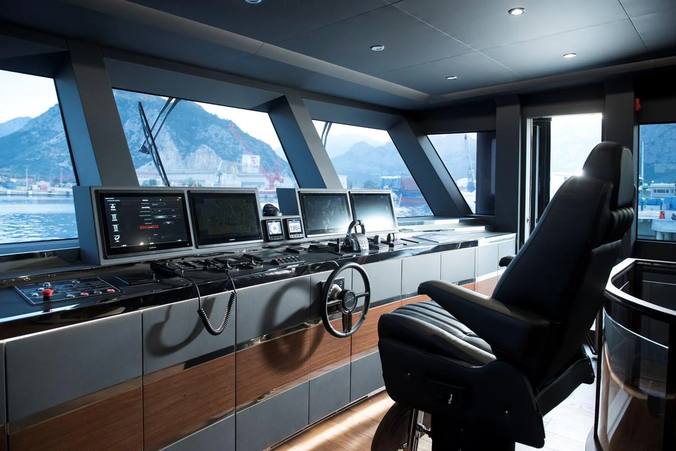 The helm station offers a sleek and modern command center with panoramic views. aboard LAZZARA UHV 90 Yacht for Sale