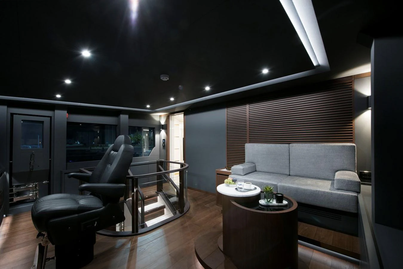 The yacht's interior lounge features modern furnishings and ambient lighting for a luxurious experience. aboard LAZZARA UHV 90 Yacht for Sale
