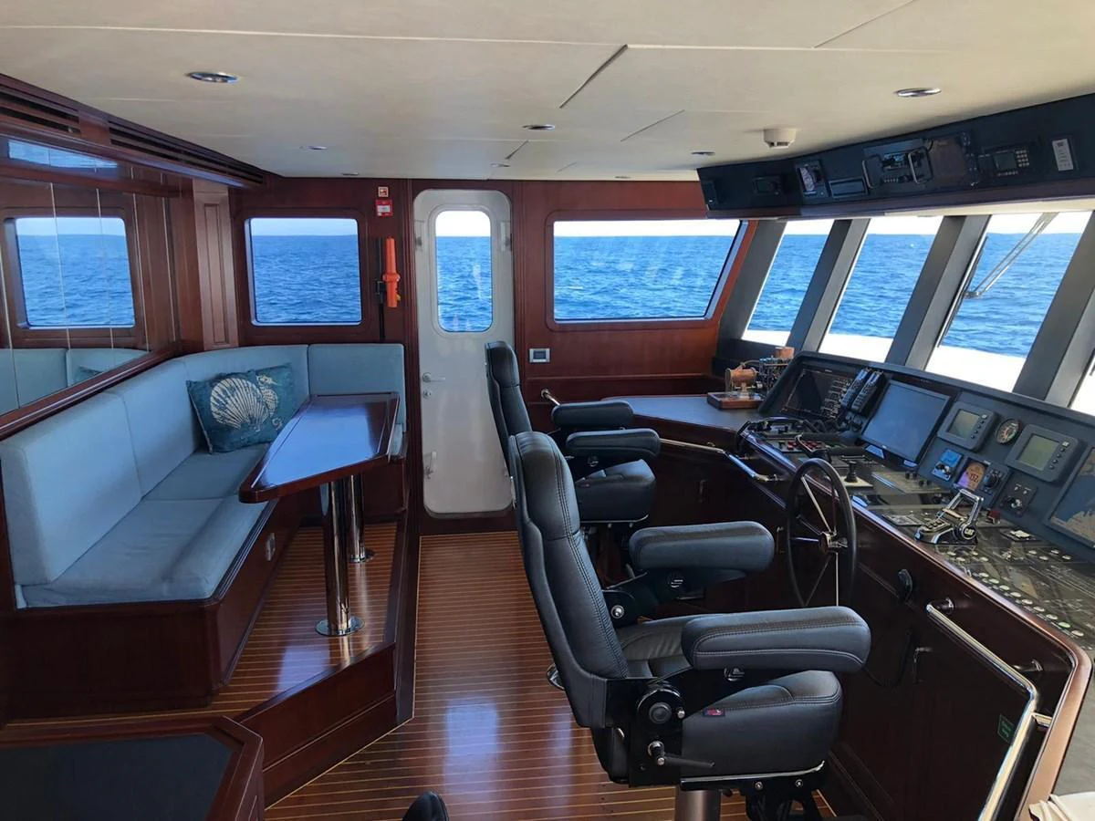 The helm of the yacht features advanced navigation equipment and a comfortable seating area with a view of the sea. aboard SAMSARA Yacht for Sale