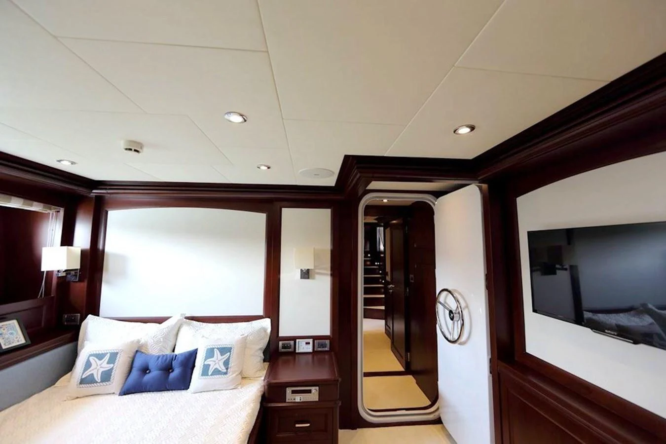 A luxurious stateroom featuring elegant wood paneling and modern amenities. aboard SAMSARA Yacht for Sale