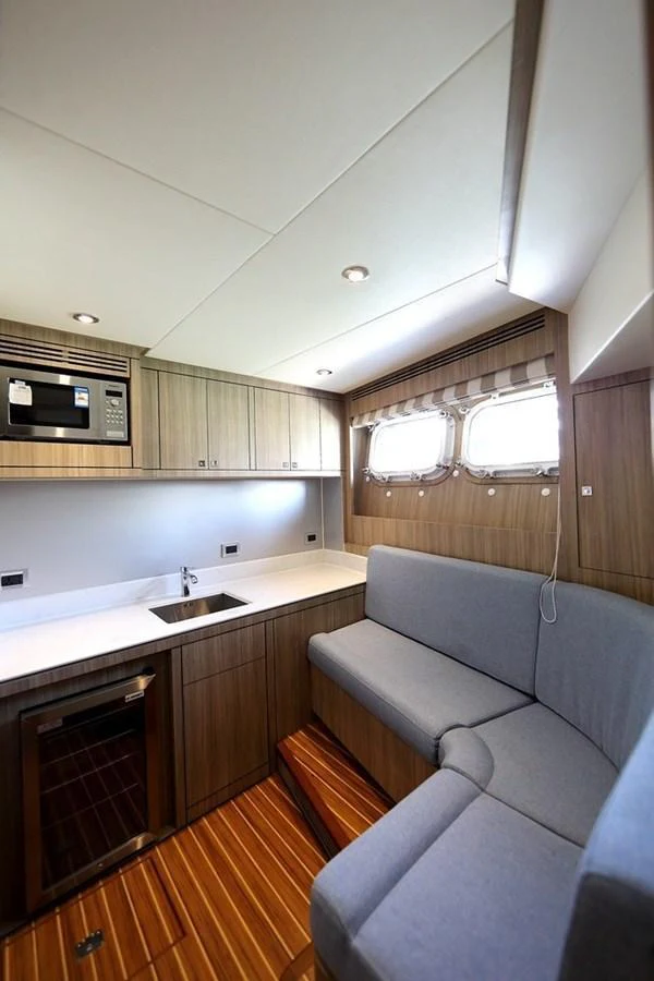 The galley features modern appliances, ample counter space, and a cozy seating area with natural light from the windows. aboard SAMSARA Yacht for Sale