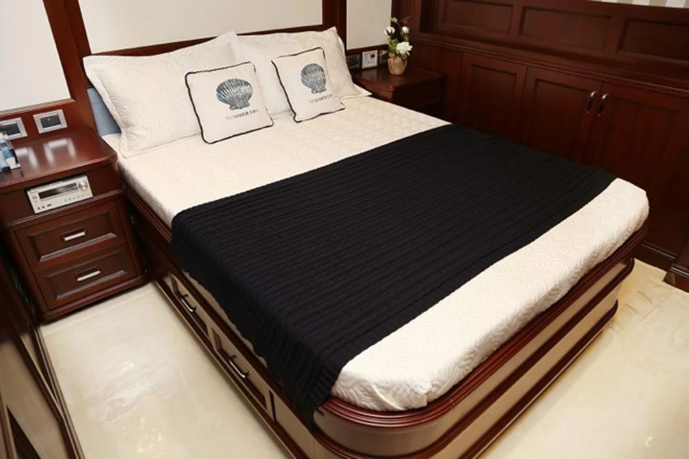 A cozy stateroom featuring a neatly made bed with elegant bedding. aboard SAMSARA Yacht for Sale