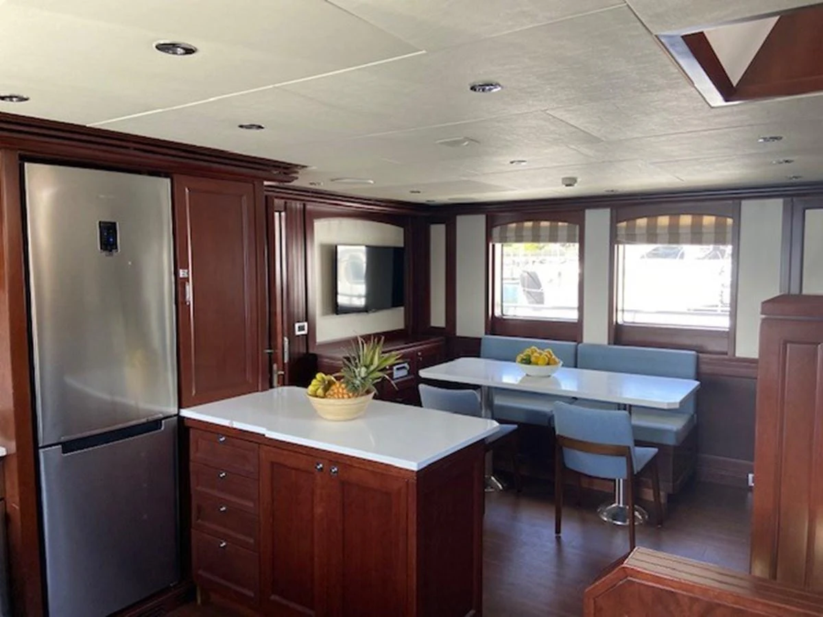 The galley features a spacious dining area with a modern kitchen setup and ample natural light. aboard SAMSARA Yacht for Sale