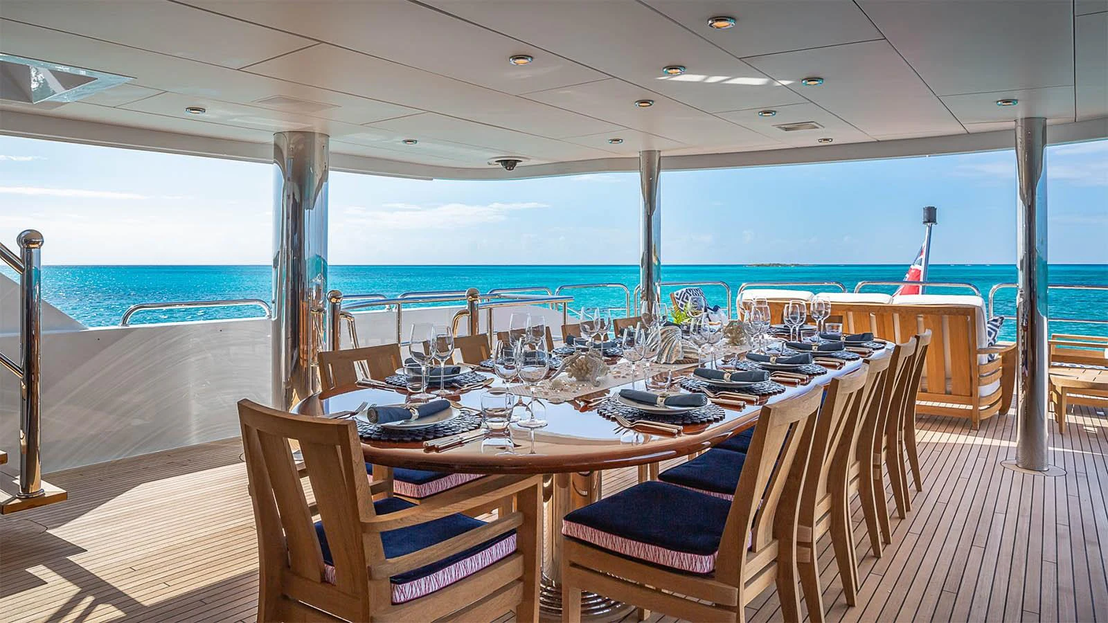 The aft deck features an elegant dining area with a stunning ocean view. aboard CARTE BLANCHE Yacht for Sale