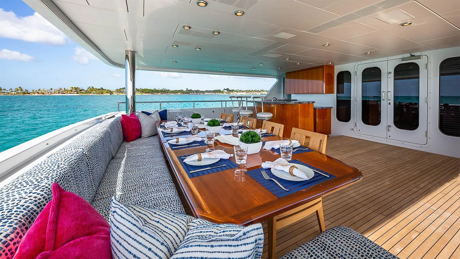 The aft deck features a spacious dining area with a beautiful view of the water. aboard CARTE BLANCHE Yacht for Sale