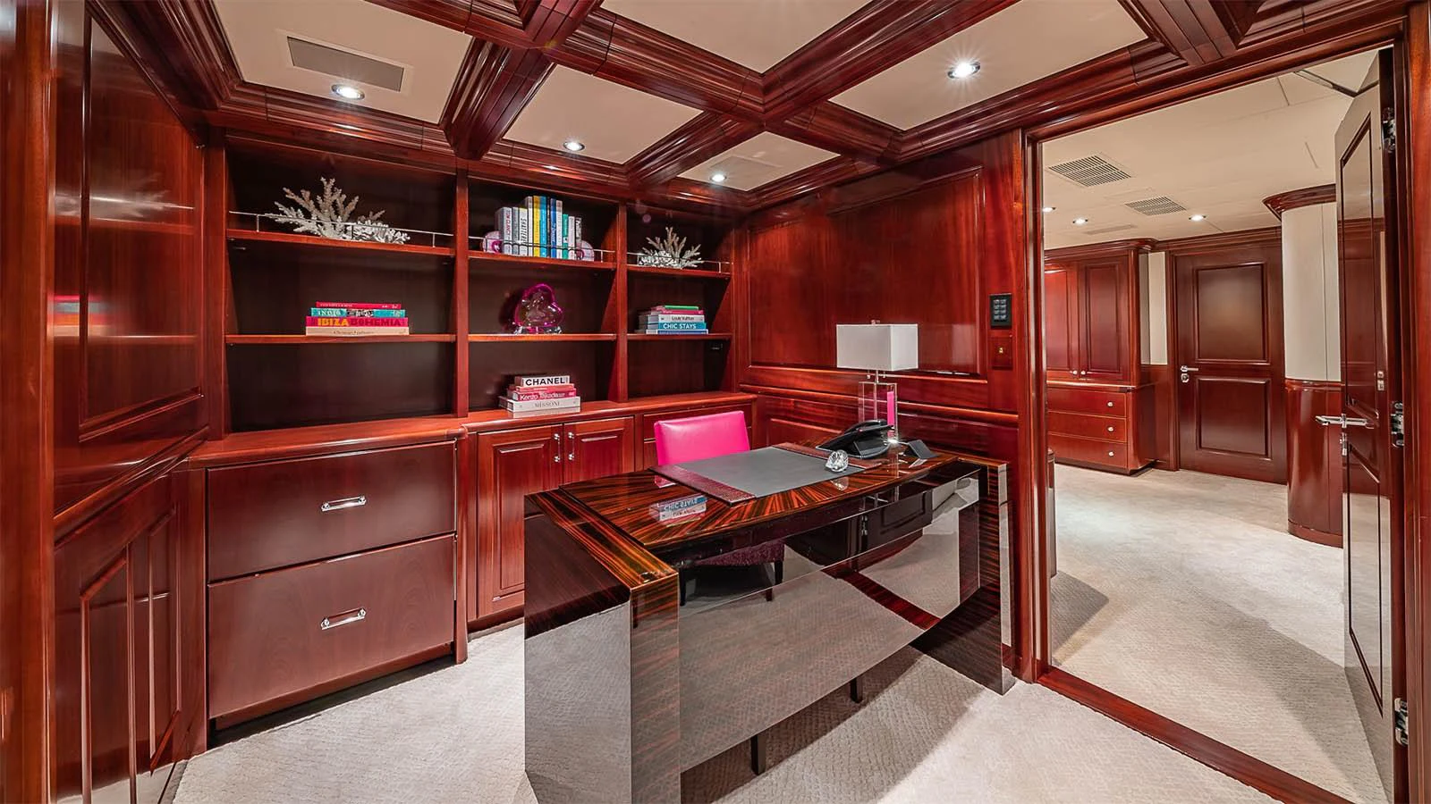 The yacht's office features rich wood paneling, a sleek desk, and built-in shelving for a sophisticated workspace. aboard CARTE BLANCHE Yacht for Sale