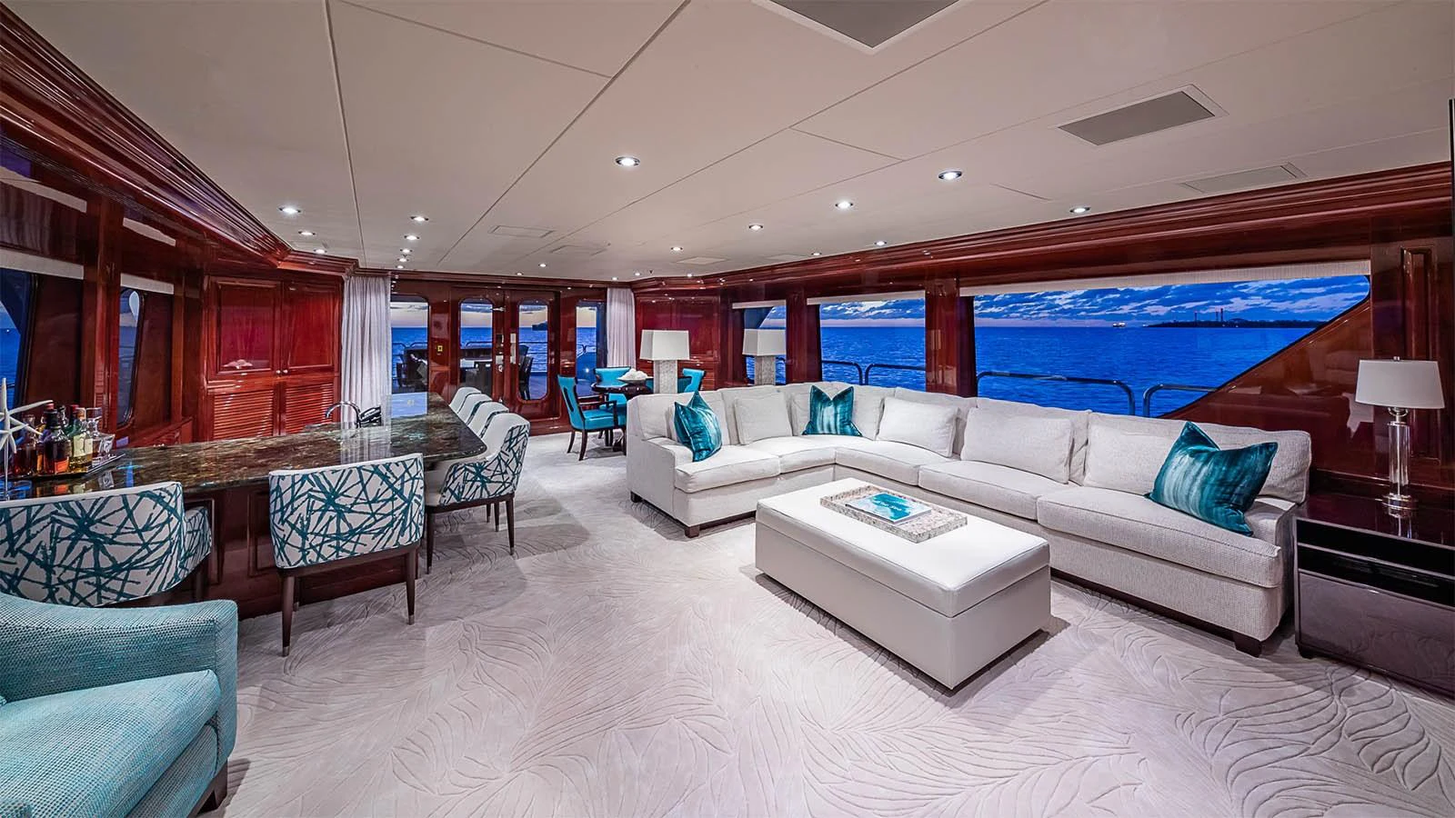 The spacious salon features elegant seating with panoramic ocean views. aboard CARTE BLANCHE Yacht for Sale