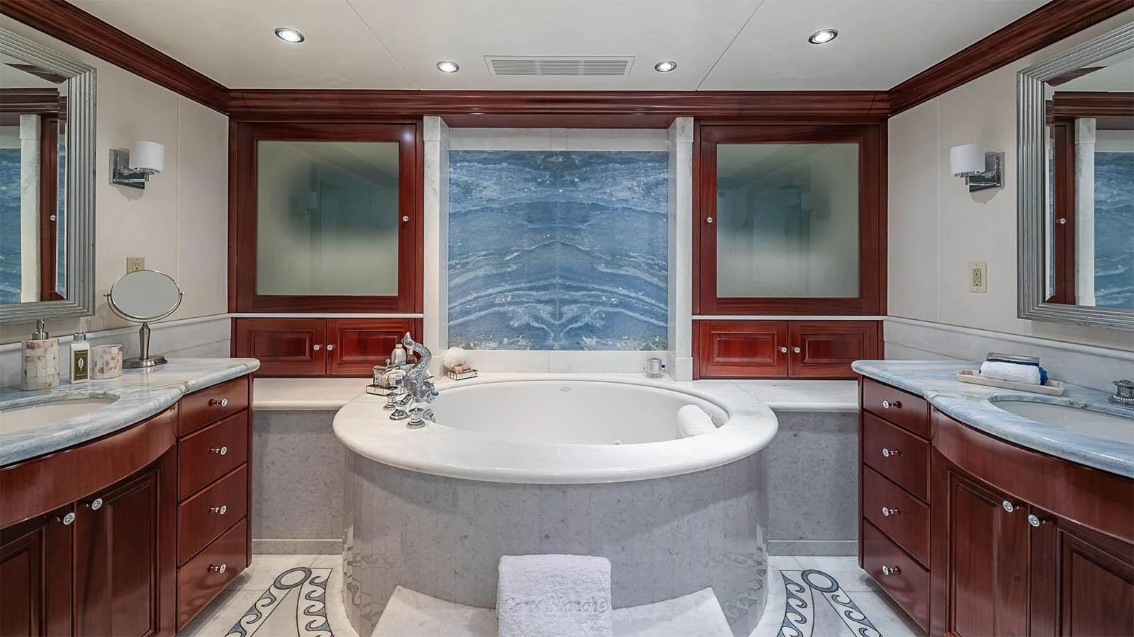 The luxurious bathroom features a central bathtub with elegant marble accents and ample counter space. aboard CARTE BLANCHE Yacht for Sale