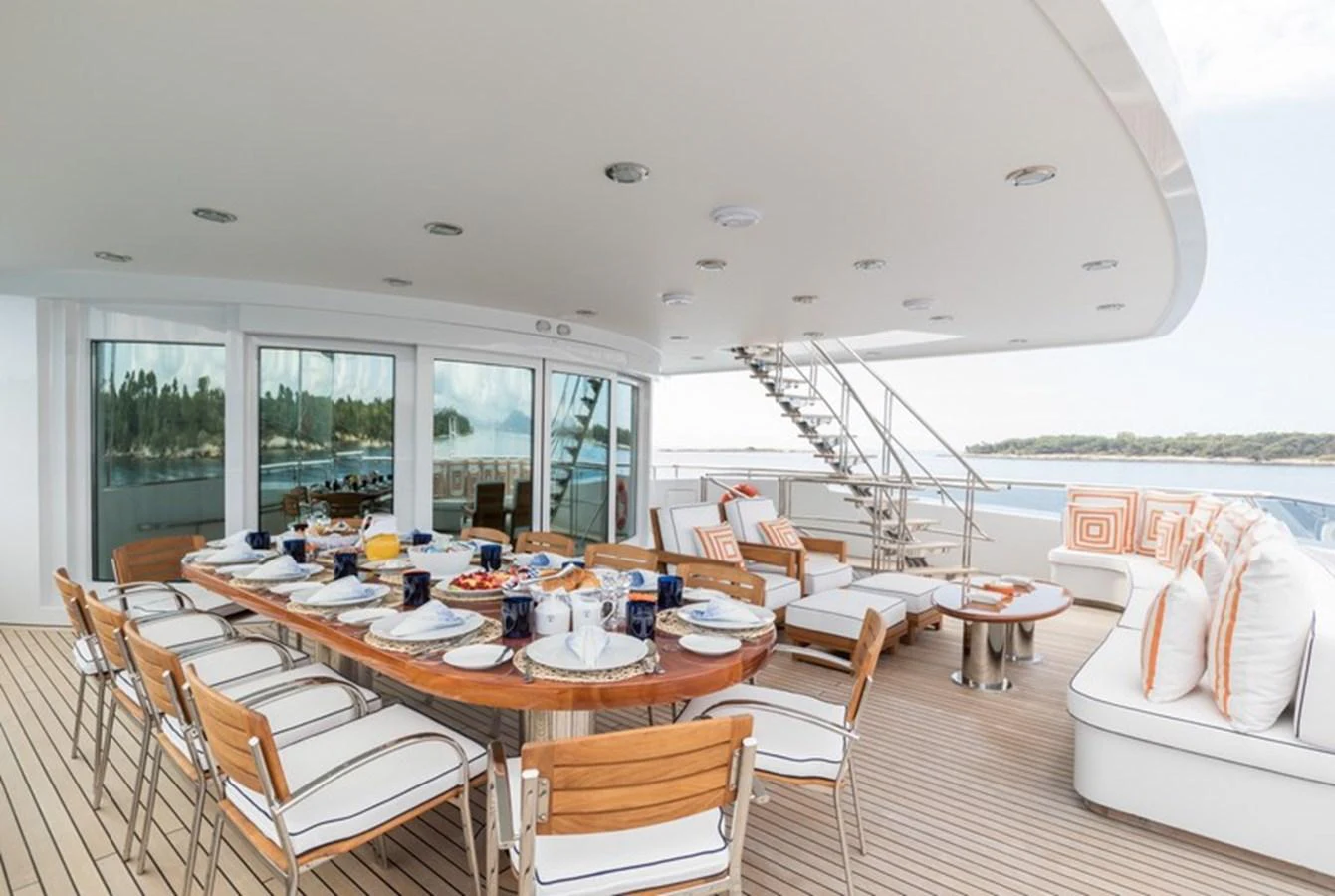 The aft deck features an elegant dining area with a large table and comfortable seating, perfect for alfresco meals. aboard LA TANIA Yacht for Sale