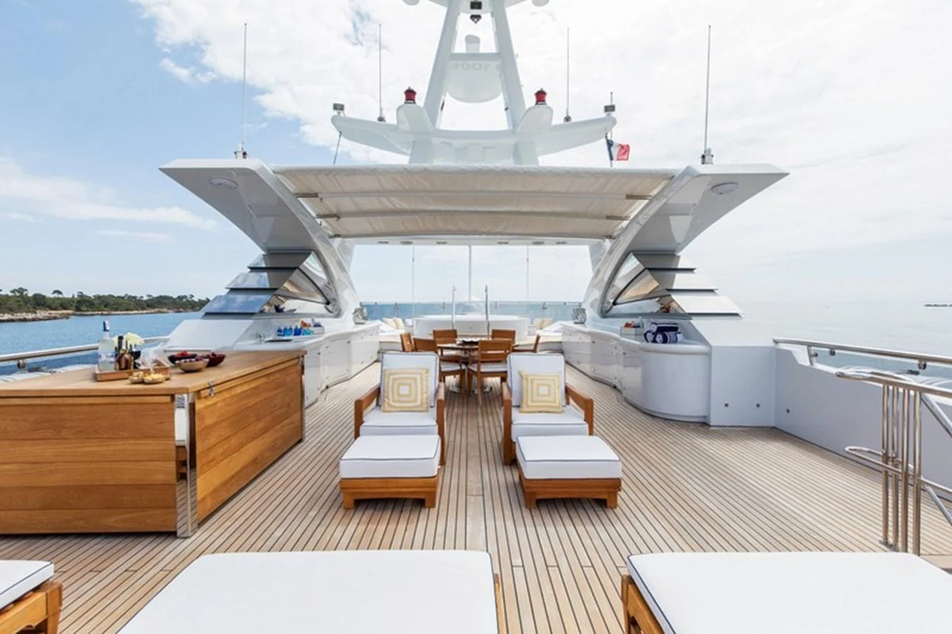 The aft deck features luxurious sun loungers and a dining area, perfect for relaxation and entertaining. aboard LA TANIA Yacht for Sale