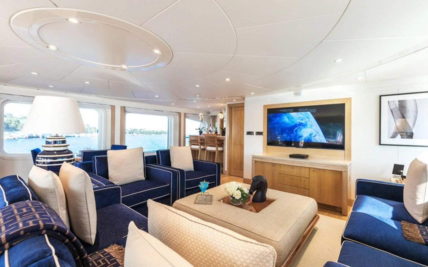 The salon features luxurious seating with a large TV and elegant decor. aboard LA TANIA Yacht for Sale