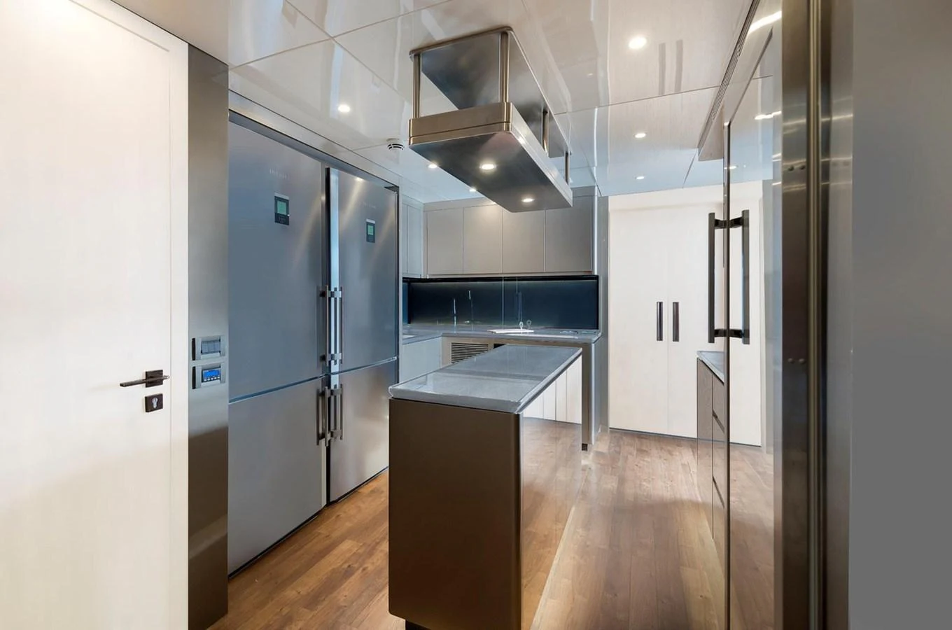 The yacht's galley is modern and spacious, featuring sleek stainless steel appliances and ample counter space. aboard CMB47-107 Yacht for Sale