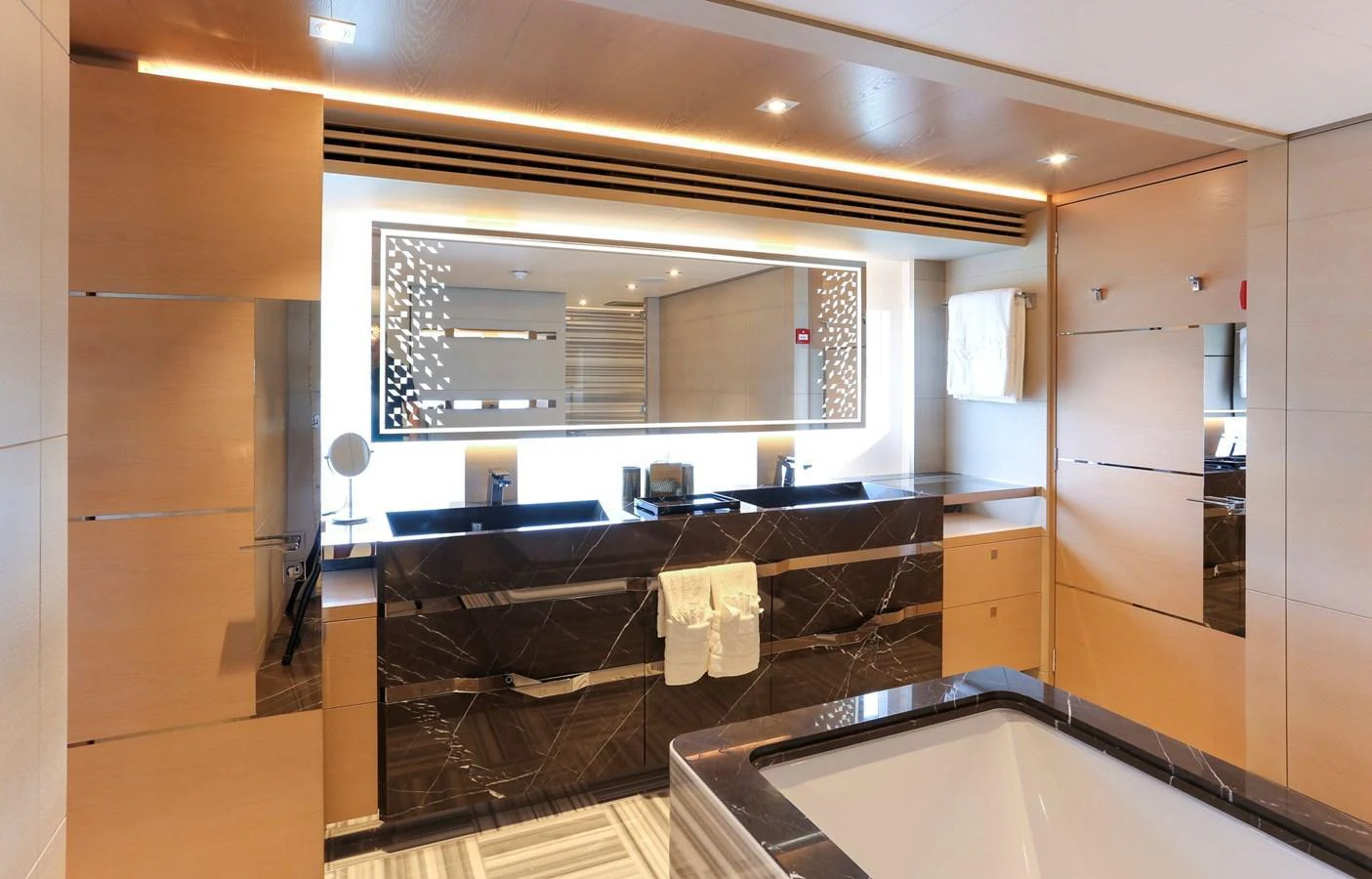 This luxurious yacht bathroom features elegant marble countertops and modern fixtures. aboard HEESEN 47M Yacht for Sale