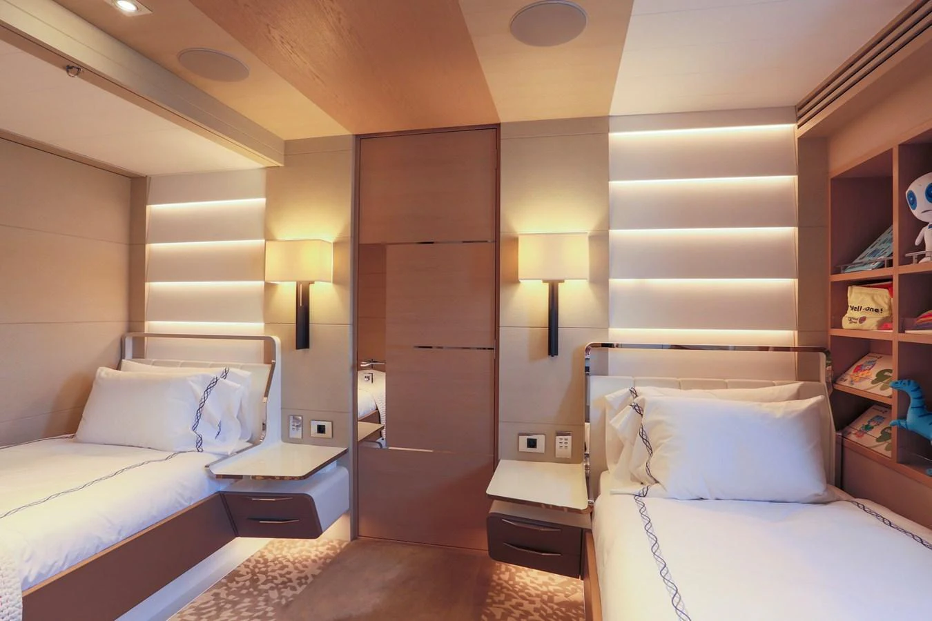 The guest stateroom features twin beds with modern lighting and elegant decor. aboard HEESEN 47M Yacht for Sale