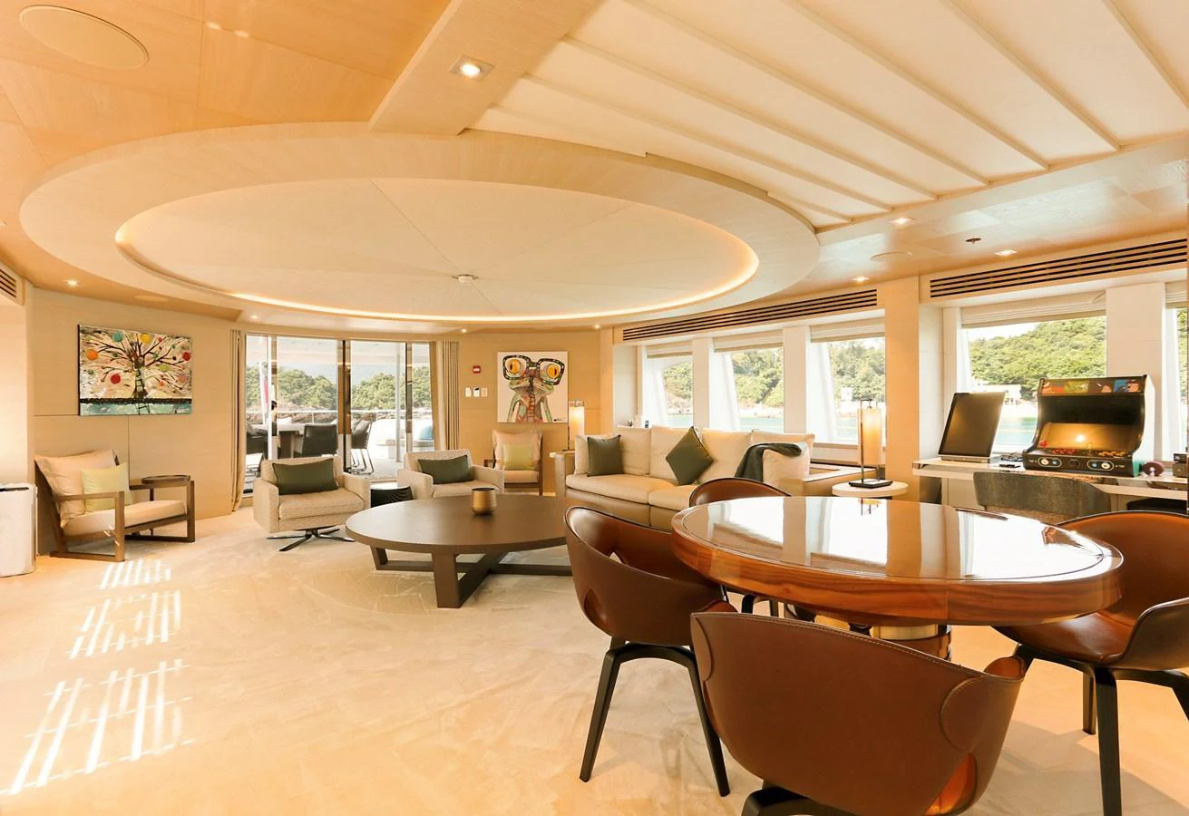 The spacious and elegantly designed interior lounge offers a luxurious and comfortable setting with ample seating and natural light. aboard HEESEN 47M Yacht for Sale