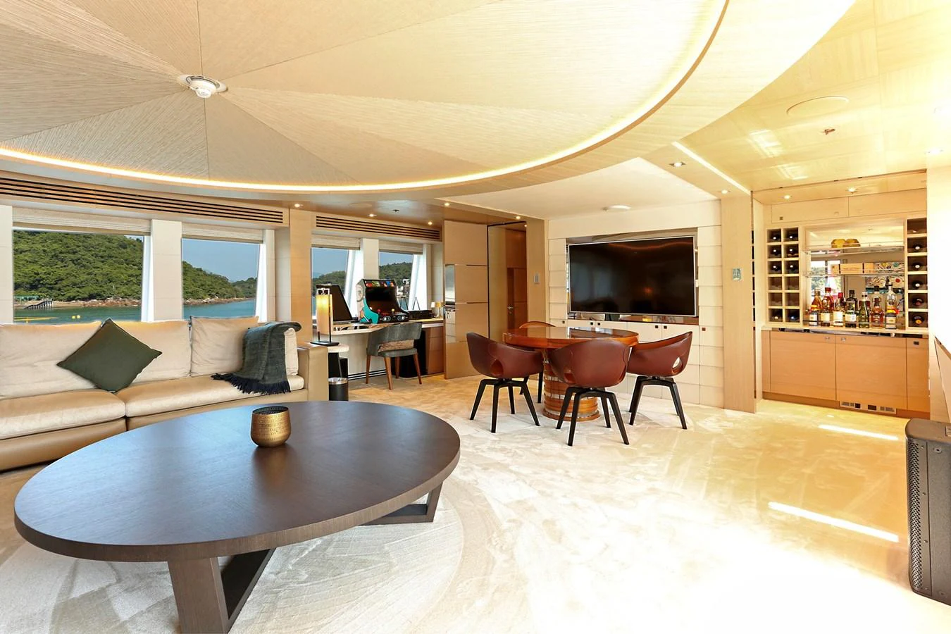 The spacious salon features elegant furnishings and a well-stocked bar, offering a luxurious and comfortable setting. aboard HEESEN 47M Yacht for Sale