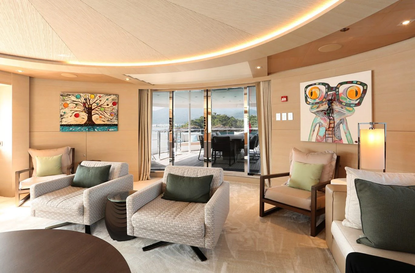 The salon features modern decor with comfortable seating and large windows offering a view of the deck. aboard HEESEN 47M Yacht for Sale