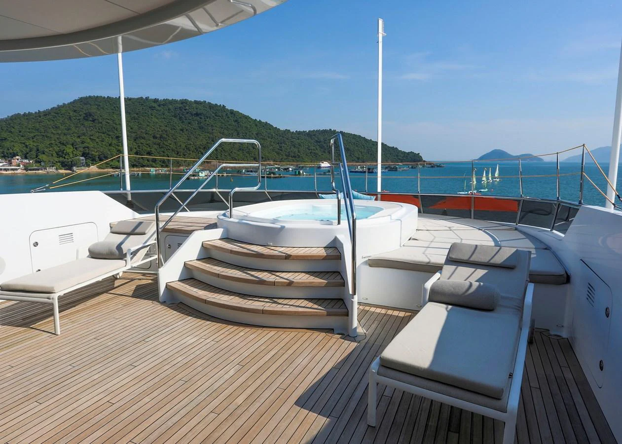 The sundeck features a luxurious jacuzzi surrounded by comfortable sun loungers, offering stunning views of the sea. aboard HEESEN 47M Yacht for Sale