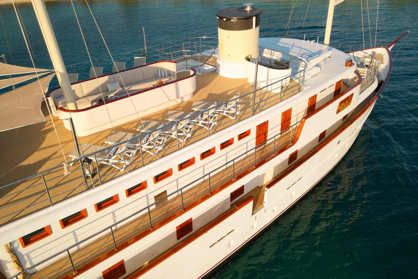 A luxurious yacht with a spacious upper deck featuring ample seating and elegant design. aboard BELLEZZA Yacht for Sale