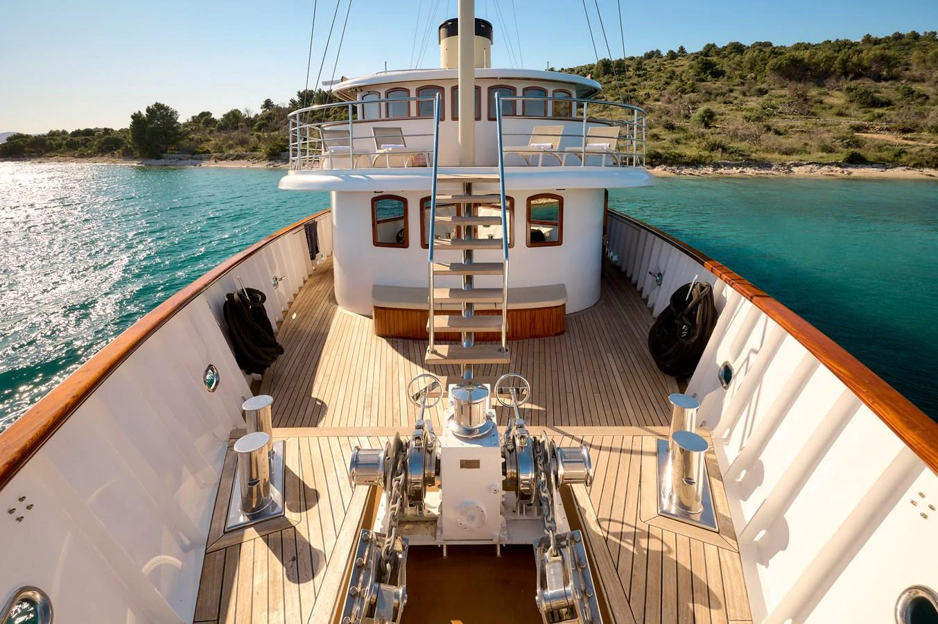 The foredeck of this yacht offers a spacious and inviting area with beautiful wood decking and polished metal fixtures. aboard BELLEZZA Yacht for Sale