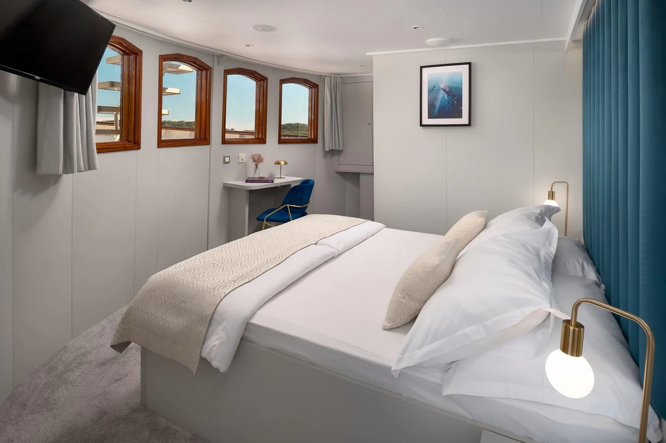 A cozy stateroom featuring a comfortable bed, modern decor, and ample natural light from multiple windows. aboard BELLEZZA Yacht for Sale
