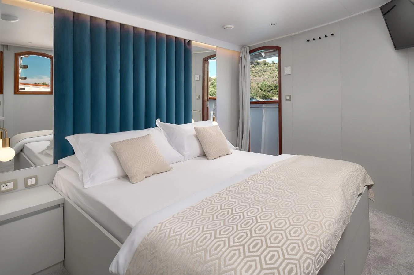 The stateroom features a plush bed with elegant bedding and a serene ambiance. aboard BELLEZZA Yacht for Sale