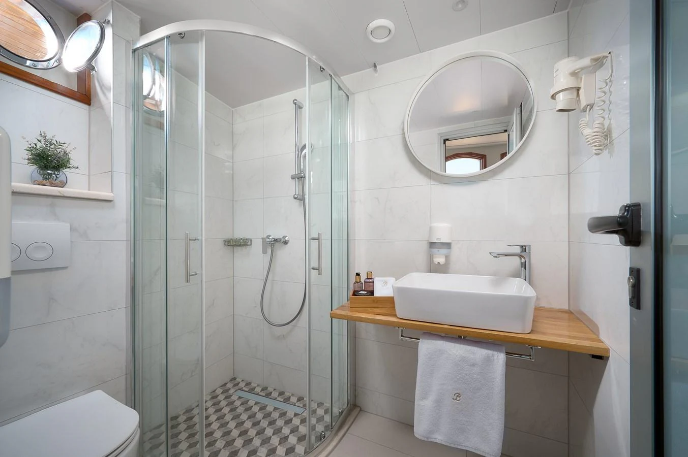 A modern yacht bathroom with a glass-enclosed shower and sleek fixtures. aboard BELLEZZA Yacht for Sale