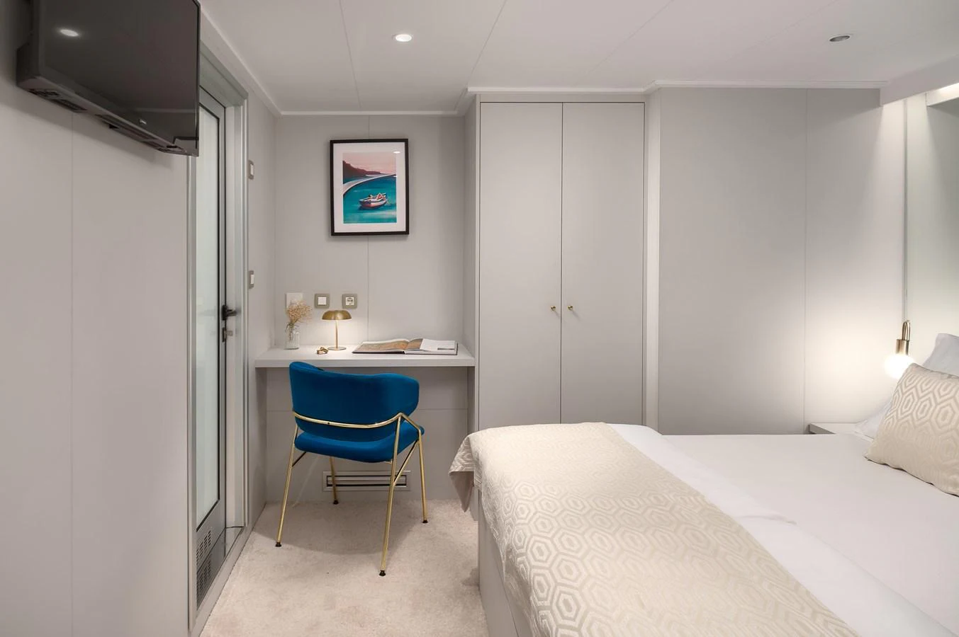 A cozy stateroom featuring a comfortable bed and a small desk area. aboard BELLEZZA Yacht for Sale