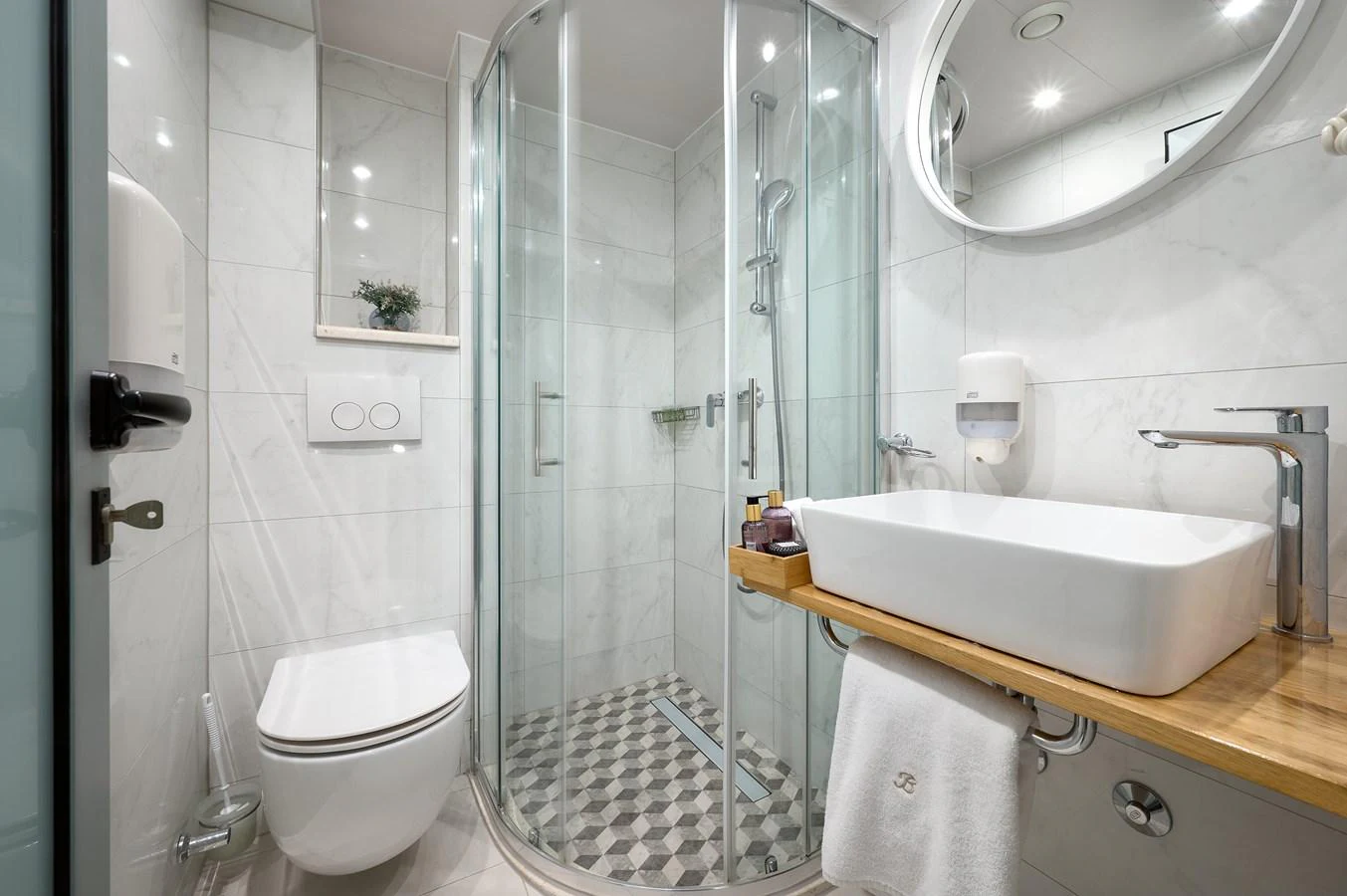 The yacht's bathroom features a modern design with a glass-enclosed shower and sleek fixtures. aboard BELLEZZA Yacht for Sale
