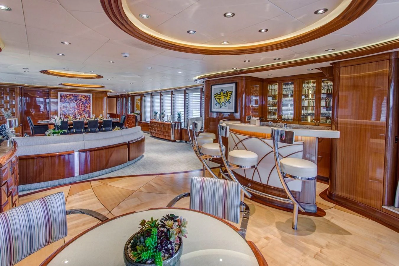 a large room with a table and chairs aboard AMICA MEA Yacht for Sale