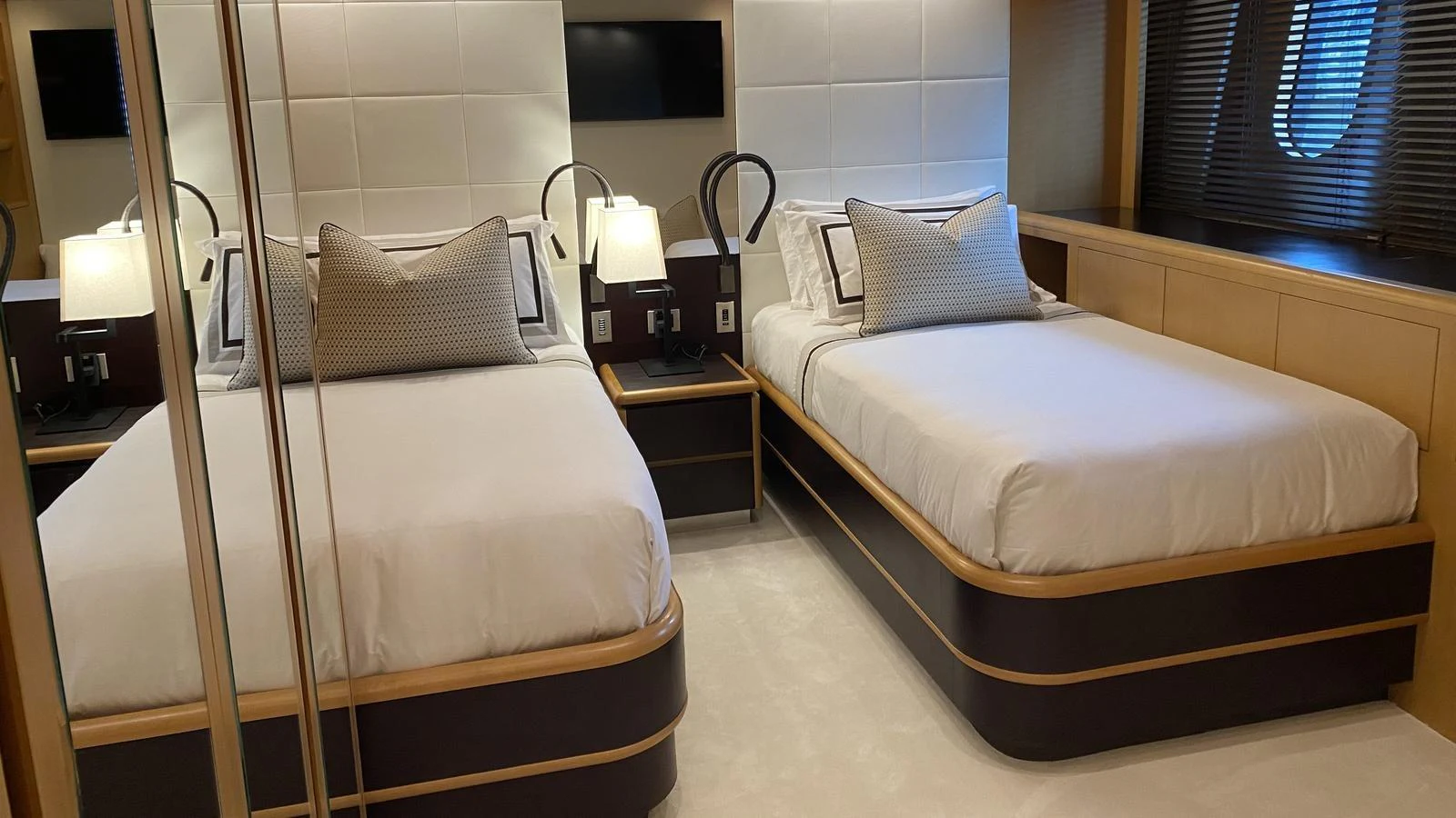 The guest stateroom features two twin beds with elegant bedding and modern lighting. aboard D'ONE D Yacht for Sale