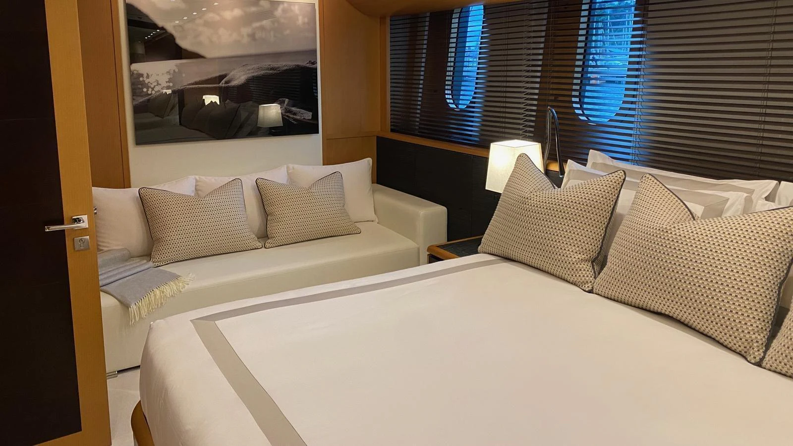 The guest stateroom features a comfortable bed, a cozy sofa, and elegant decor. aboard D'ONE D Yacht for Sale