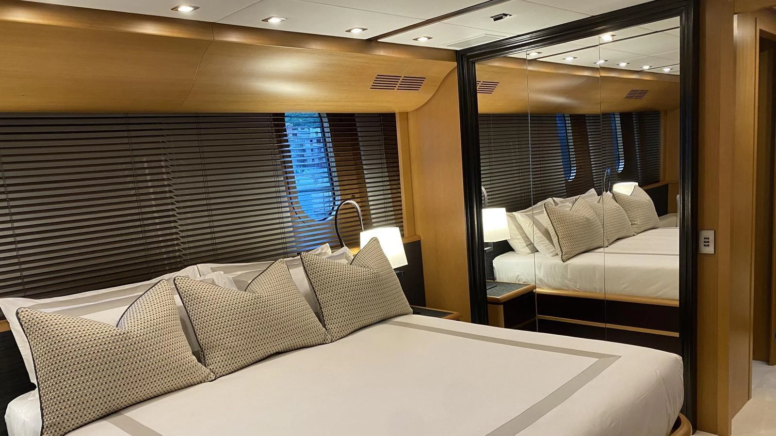 The master stateroom features a luxurious bed with elegant bedding and ample natural light. aboard D'ONE D Yacht for Sale