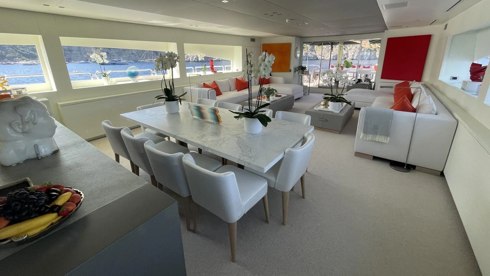 The salon features a spacious and elegant dining area with modern furnishings and large windows offering scenic views. aboard D'ONE D Yacht for Sale
