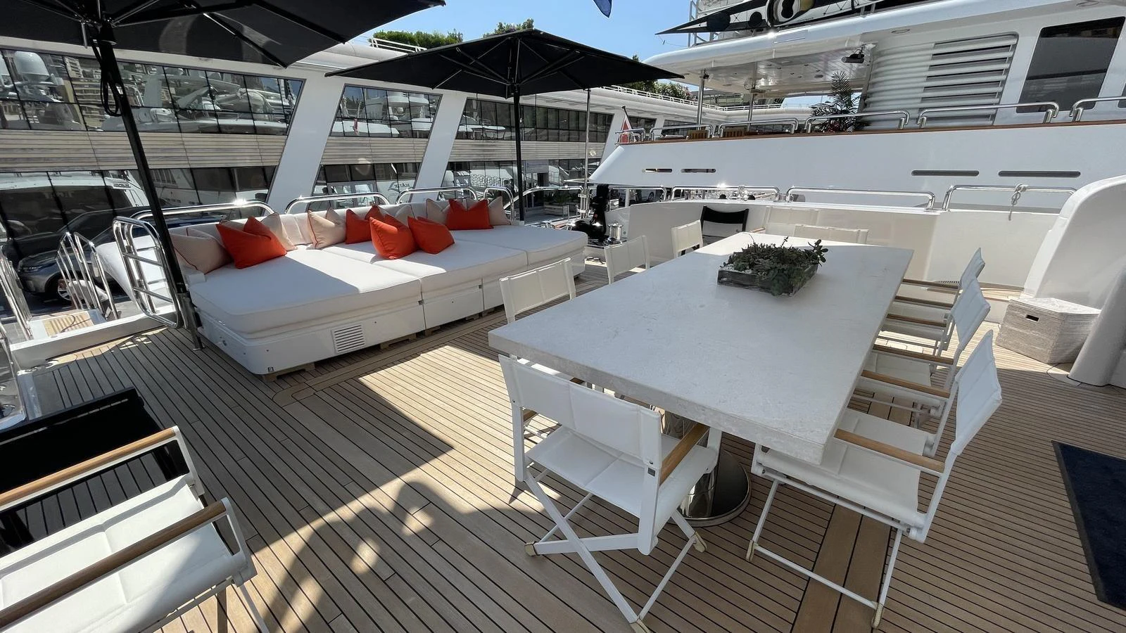 The aft deck features a spacious lounging area with comfortable seating and a large dining table, perfect for outdoor relaxation and dining. aboard D'ONE D Yacht for Sale