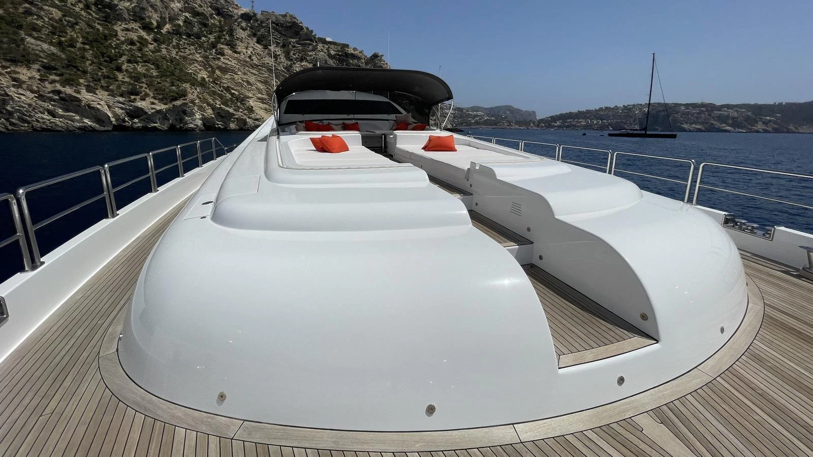 The sleek foredeck features spacious sun pads with vibrant orange cushions, perfect for relaxation. aboard D'ONE D Yacht for Sale
