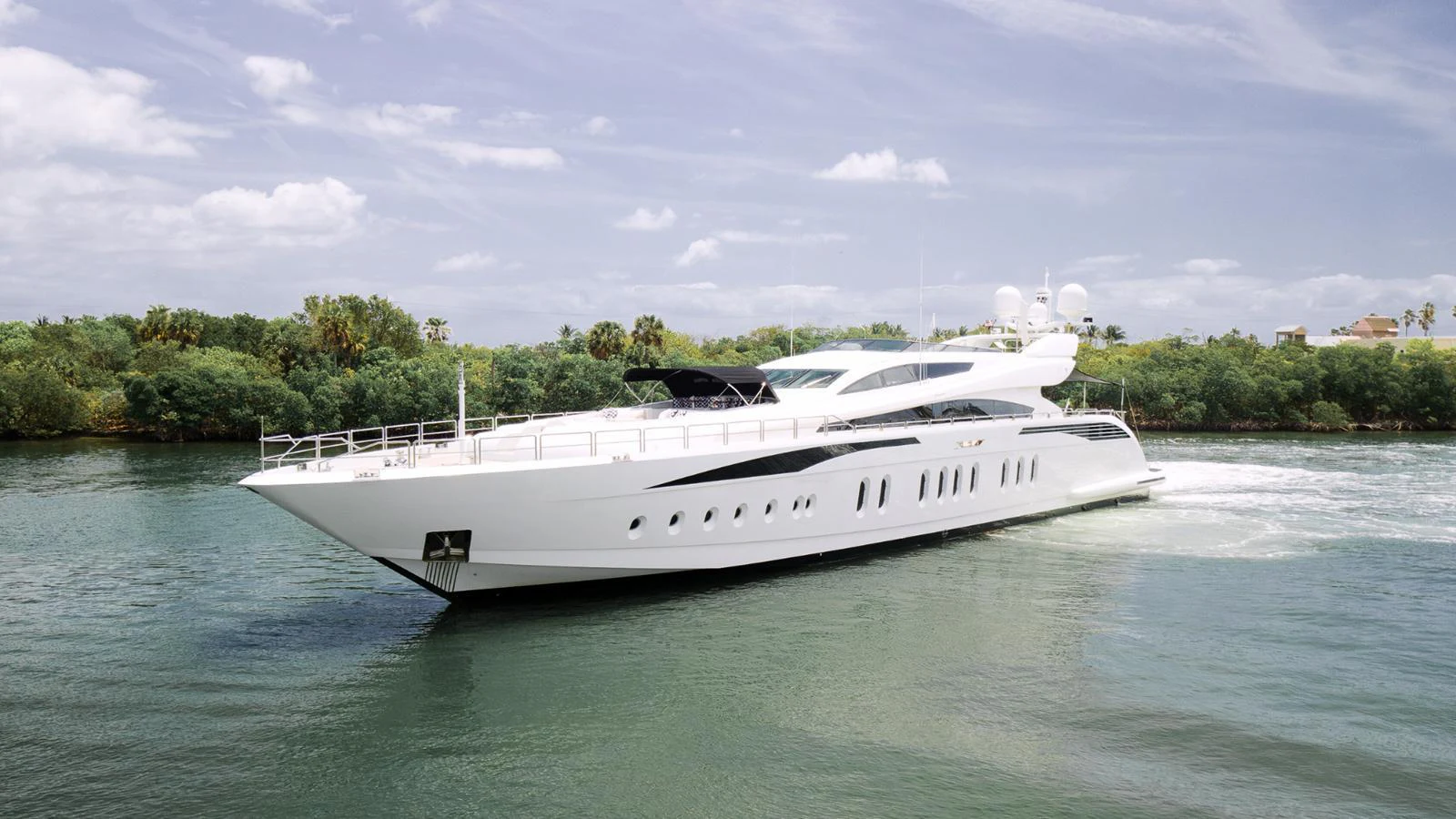 A sleek and modern yacht cruises gracefully through calm waters, showcasing its elegant design. aboard BET ON IT Yacht for Sale