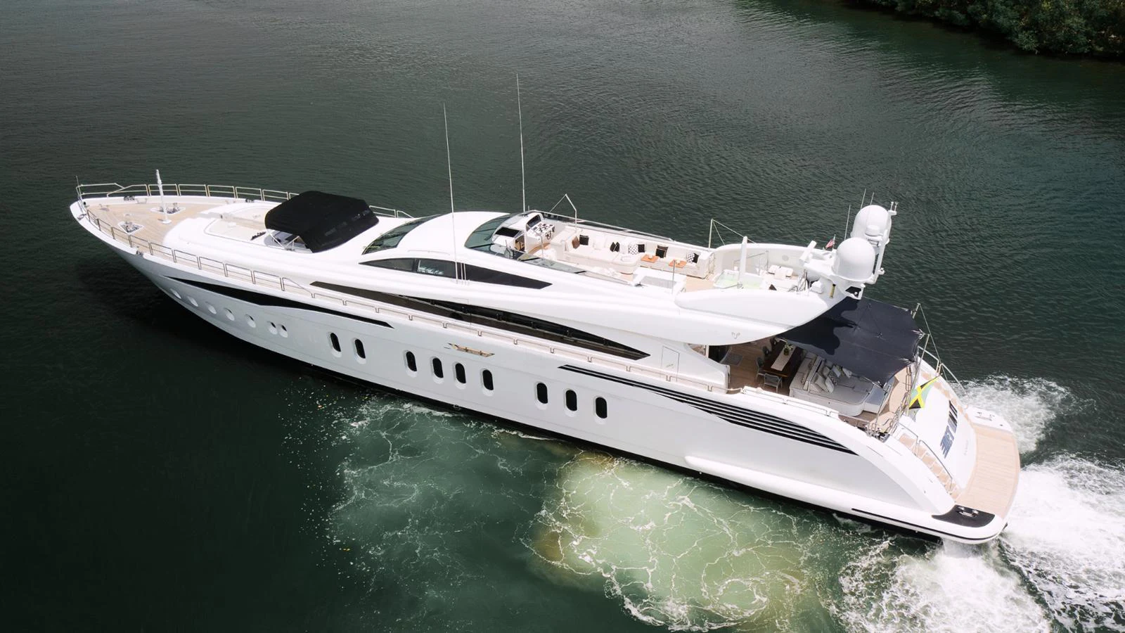 A sleek and modern yacht glides through calm waters, showcasing its elegant design and spacious deck areas. aboard BET ON IT Yacht for Sale