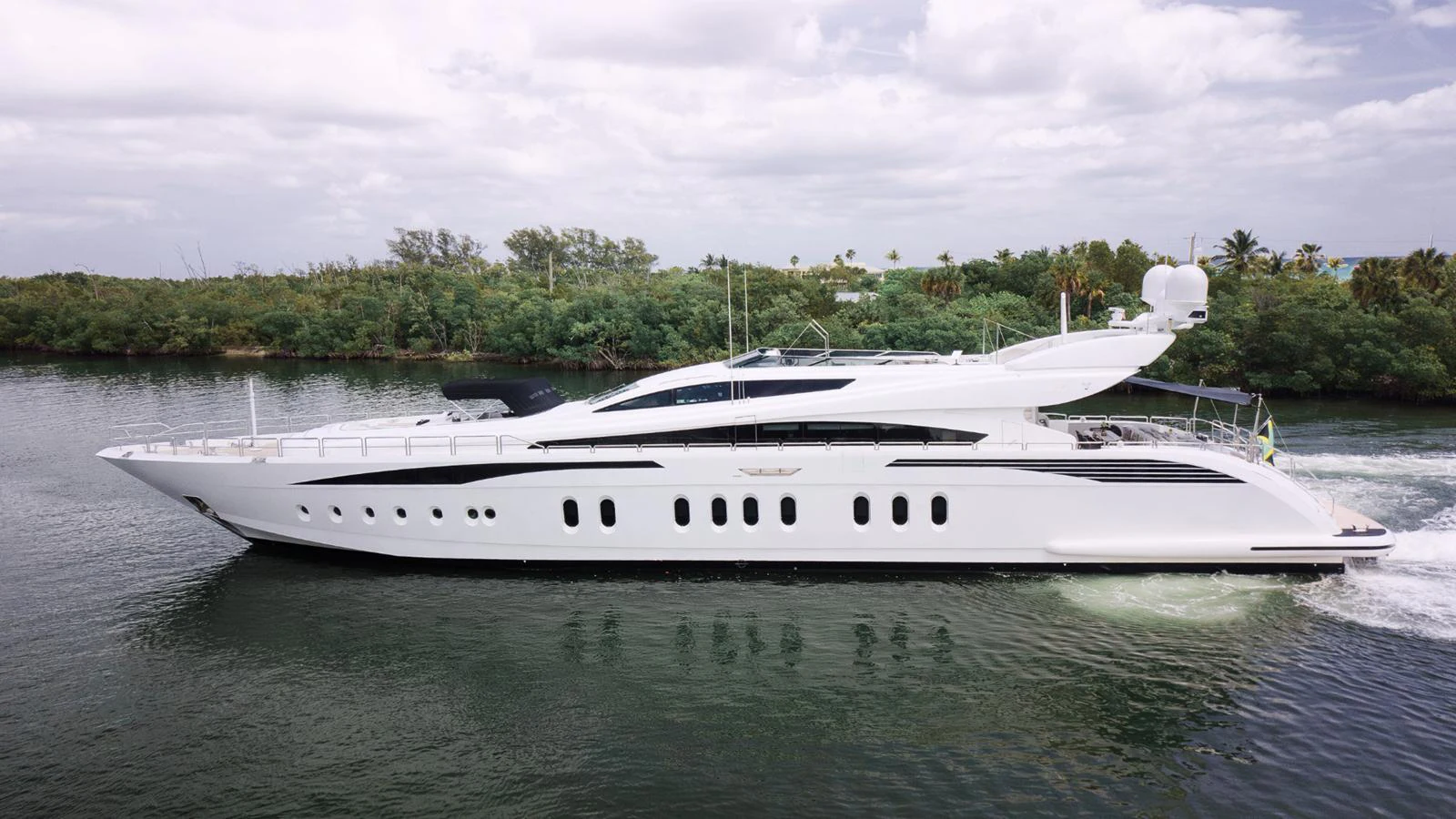 A sleek and modern yacht cruising along a serene waterway. aboard BET ON IT Yacht for Sale
