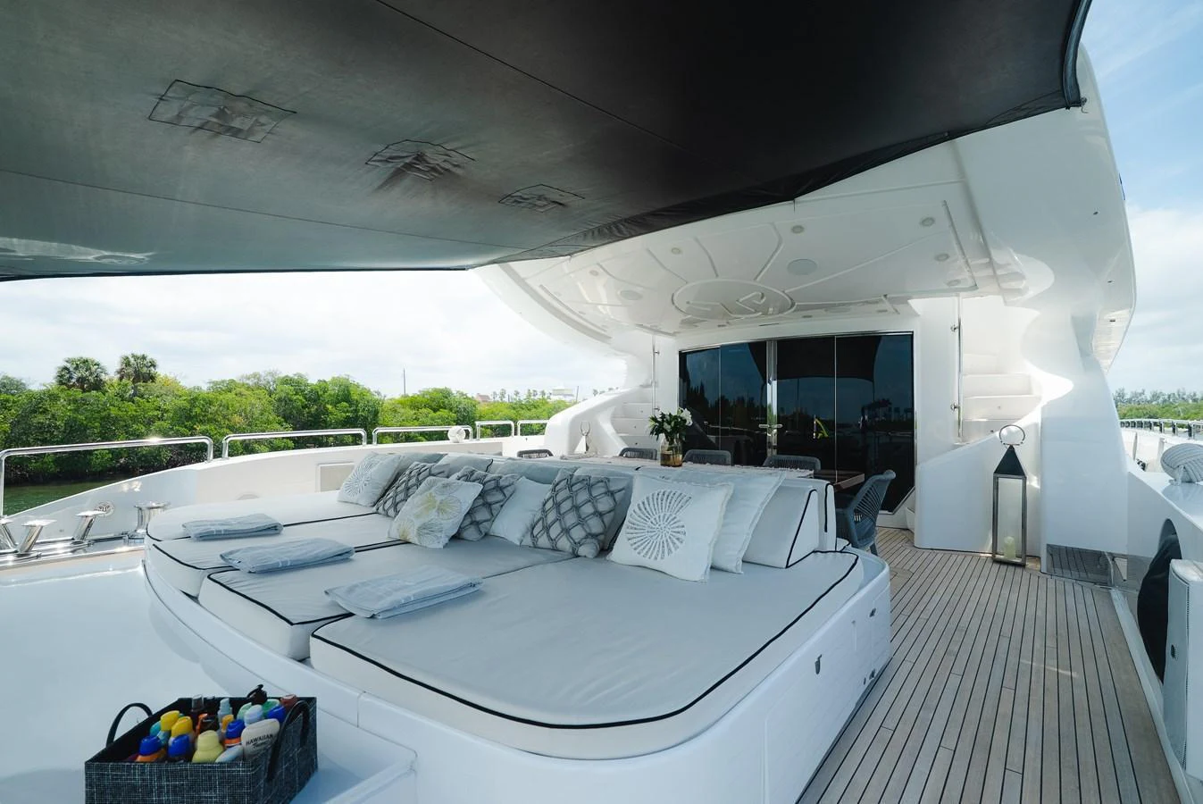 The sundeck offers a luxurious lounging area with plush sunbeds and a shaded canopy. aboard BET ON IT Yacht for Sale