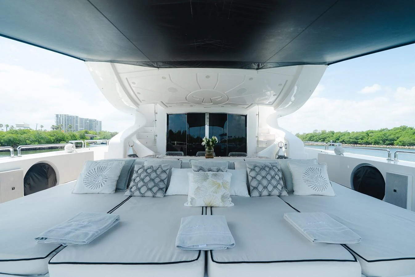 The sundeck features a spacious lounging area with comfortable cushions and pillows. aboard BET ON IT Yacht for Sale